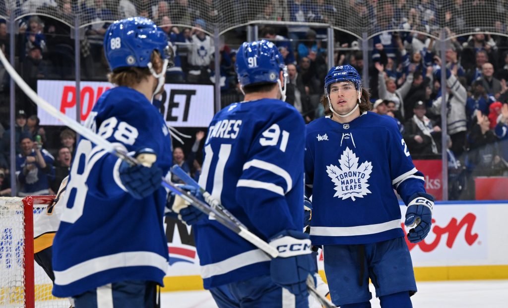 Dec 4, 2024; Toronto, Ontario, CAN; Toronto Maple Leafs forwards William Nylander (88) and John Tavares (91) acknowledge forward Matthew Knies (23) after his no-look pass set up Nylander for a goal against the Nashville Predators in the third period at Scotiabank Arena. Mandatory Credit: Dan Hamilton-Imagn Images